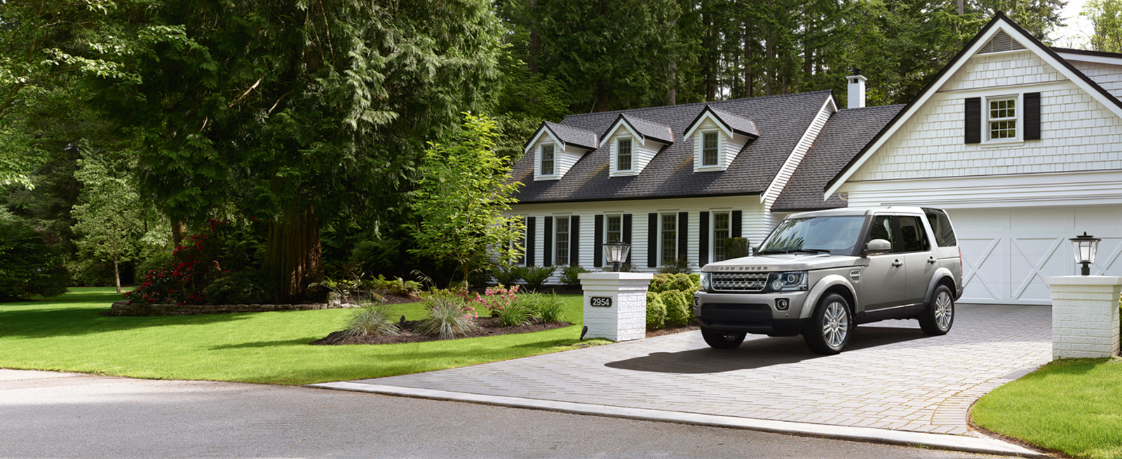 Silver Discovery sitting in the Driveway of a Modern White Farmhouse